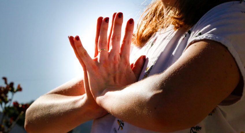 Close up of hands in gassho position.